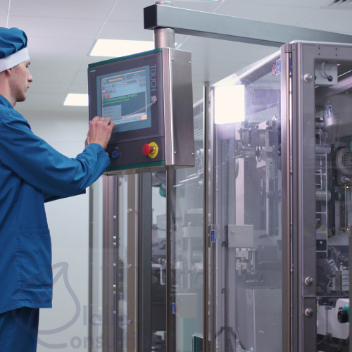 Pilot manufacturing equipment with technical personnel reviewing formulation or production data. 500X500 Pilot manufacturing equipment with technical personnel reviewing formulation or production data. 500X500